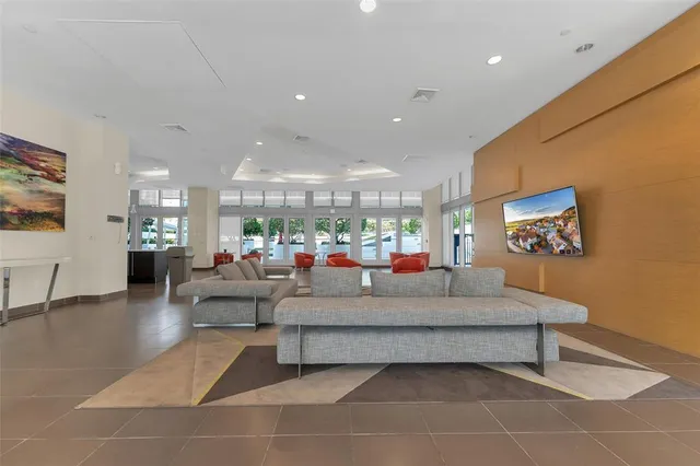 a white kitchen with a dining table chairs and white stainless steel appliances