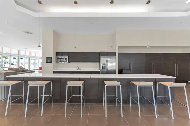 a kitchen with a table chairs and a wooden floor