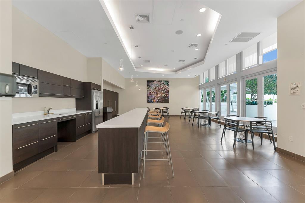 1111 Southwest 1st Avenue, Unit 1224N Miami, FL 33130 - Photo 27 of 37 a kitchen with a table chairs and a wooden floor