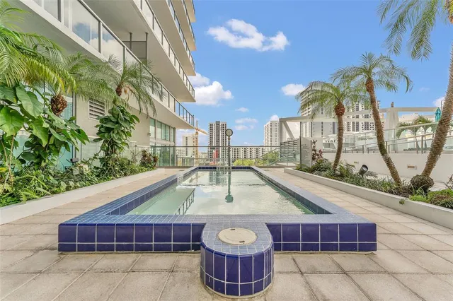 a view of swimming pool with outdoor seating and plants