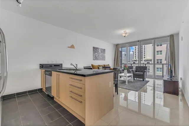 a kitchen with a dining table chairs and cabinets