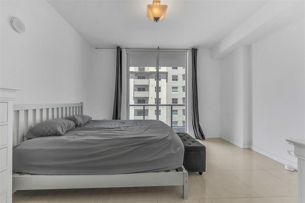 1111 Southwest 1st Avenue, Unit 1224N Miami, FL 33130 - Photo 10 of 37 a bed sitting in a bedroom next to a window
