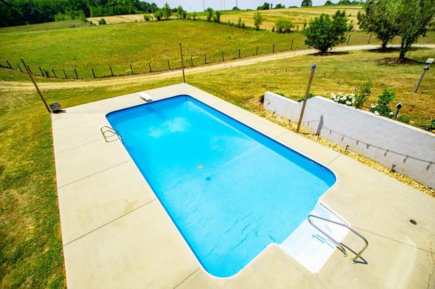 575 Liberty Church Road Carrollton, GA 30116 - Photo 63 of 95 a view of a swimming pool with an outdoor seating and a yard
