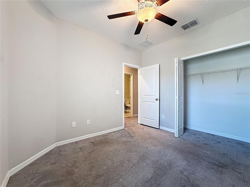 8069 Rolling Shell Trail Wesley Chapel, FL 33545 - Photo 11 of 26 an empty room with chandelier fan