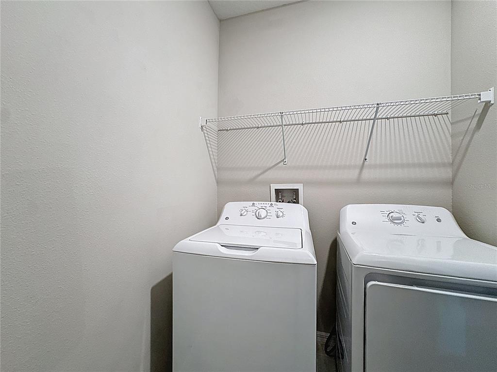 8069 Rolling Shell Trail Wesley Chapel, FL 33545 - Photo 15 of 26 a utility room with dryer and washer