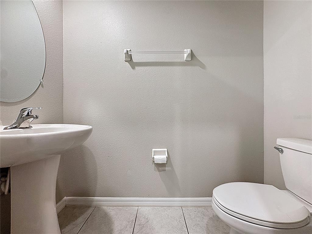 8069 Rolling Shell Trail Wesley Chapel, FL 33545 - Photo 8 of 26 a bathroom with a toilet a sink and mirror