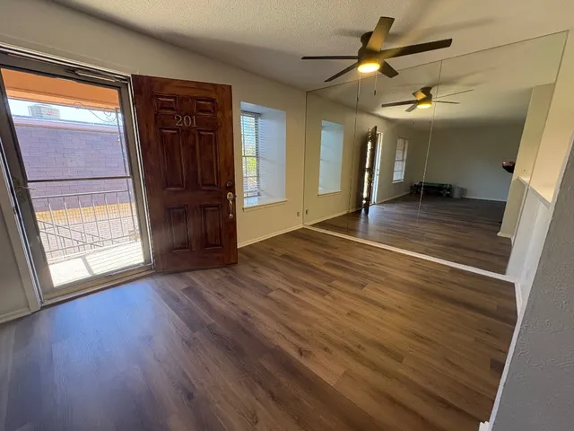 wooden floor in an empty room with a window