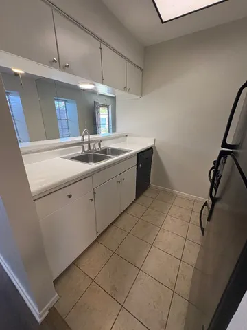 a kitchen with a sink and cabinets