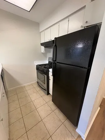 a kitchen with a sink and a refrigerator