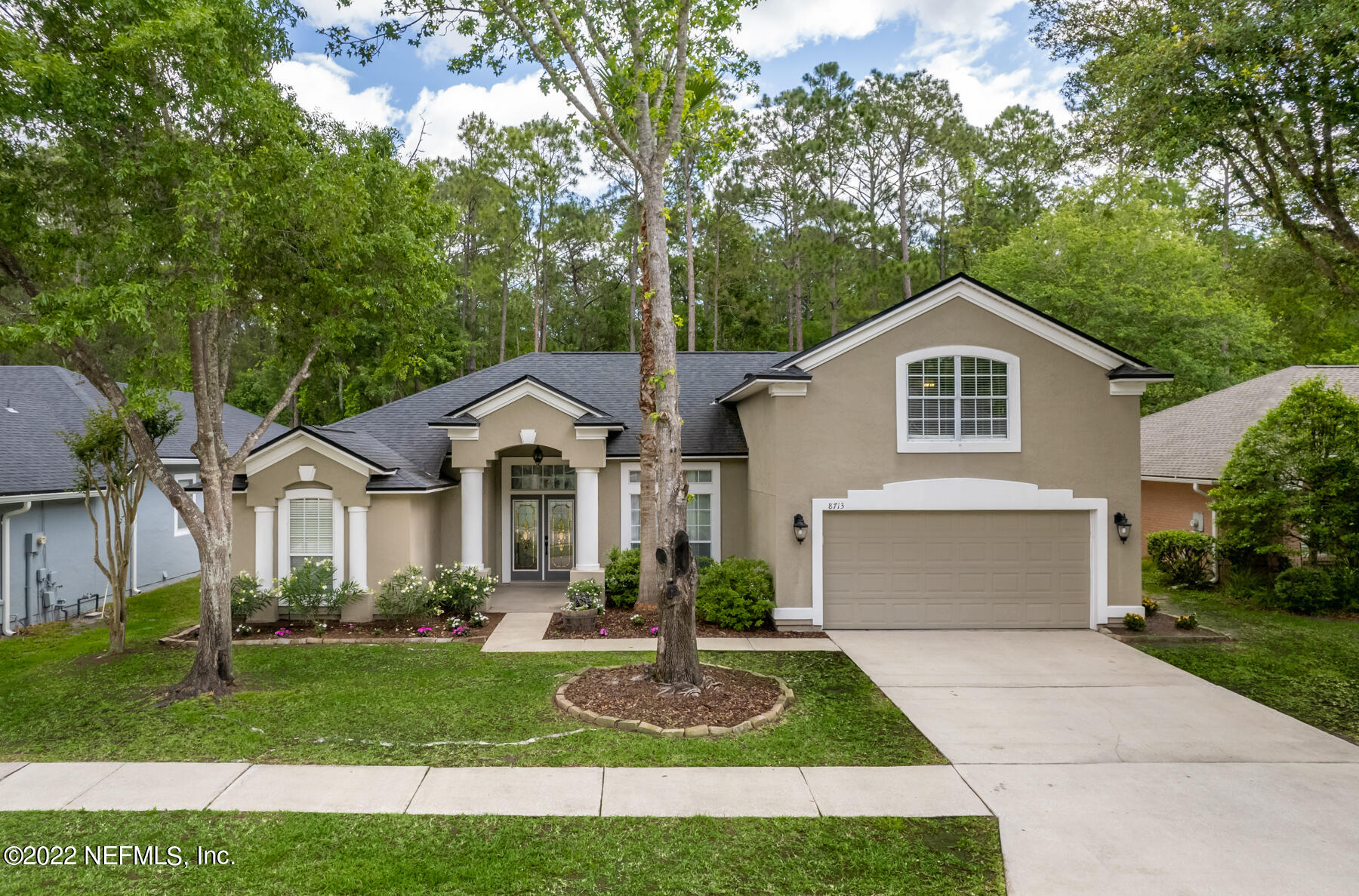 8713 Reedy Branch Drive Jacksonville, FL 32256 - Photo 1 of 38 a front view of a house with a yard