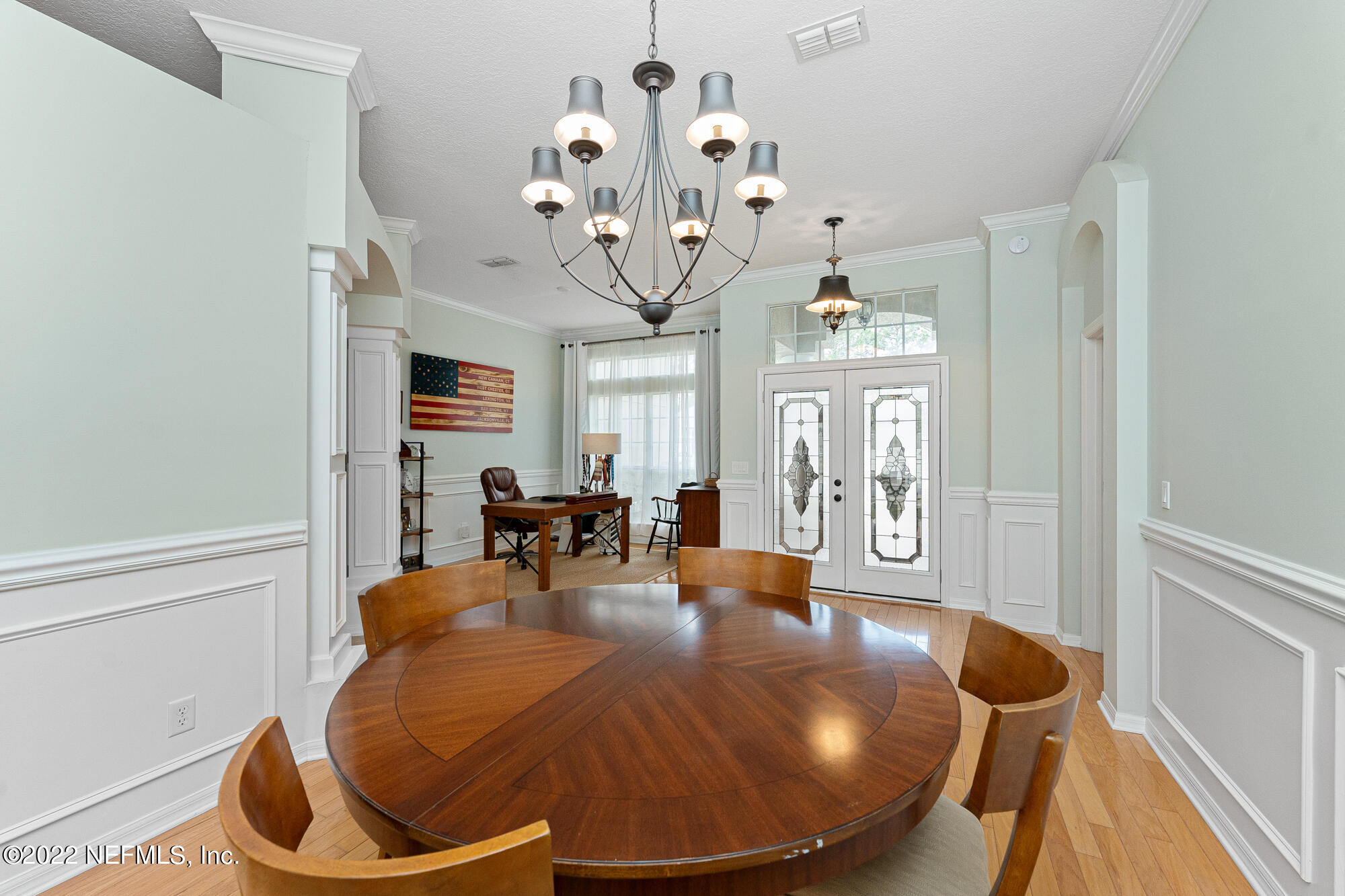 8713 Reedy Branch Drive Jacksonville, FL 32256 - Photo 11 of 38 a dining room with wooden floor chandelier table and chairs