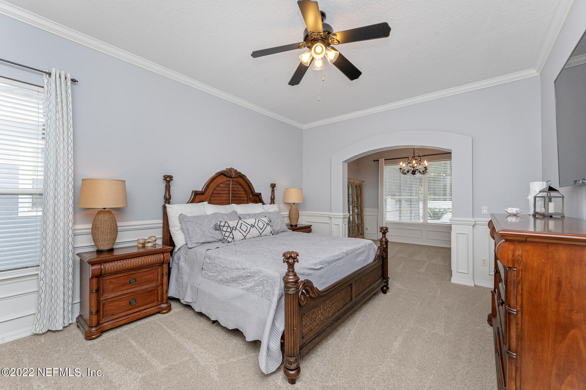 8713 Reedy Branch Drive Jacksonville, FL 32256 - Photo 19 of 38 a bedroom with a bed furniture and a chandelier