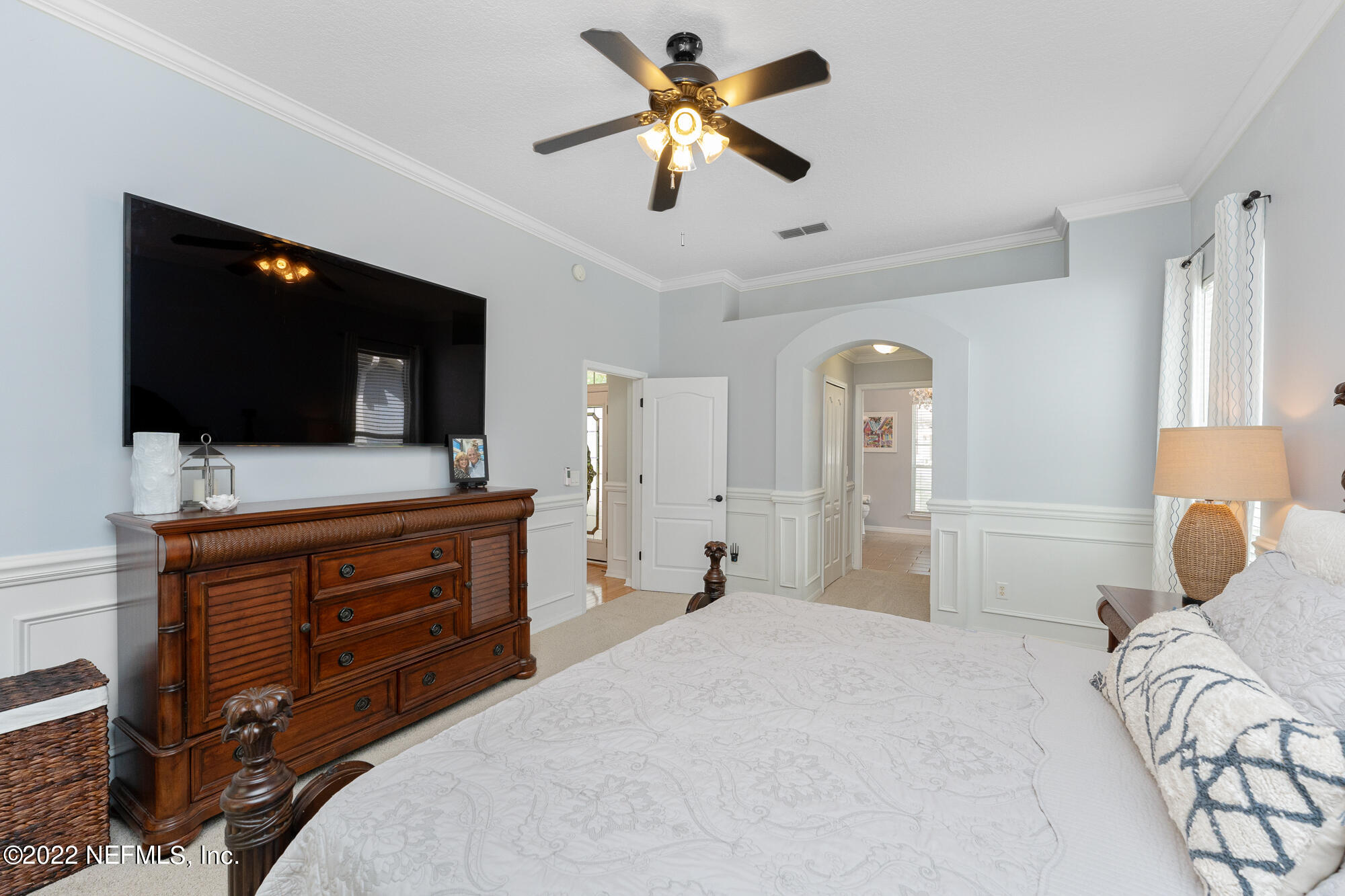 8713 Reedy Branch Drive Jacksonville, FL 32256 - Photo 21 of 38 a bedroom with a bed and a flat screen tv