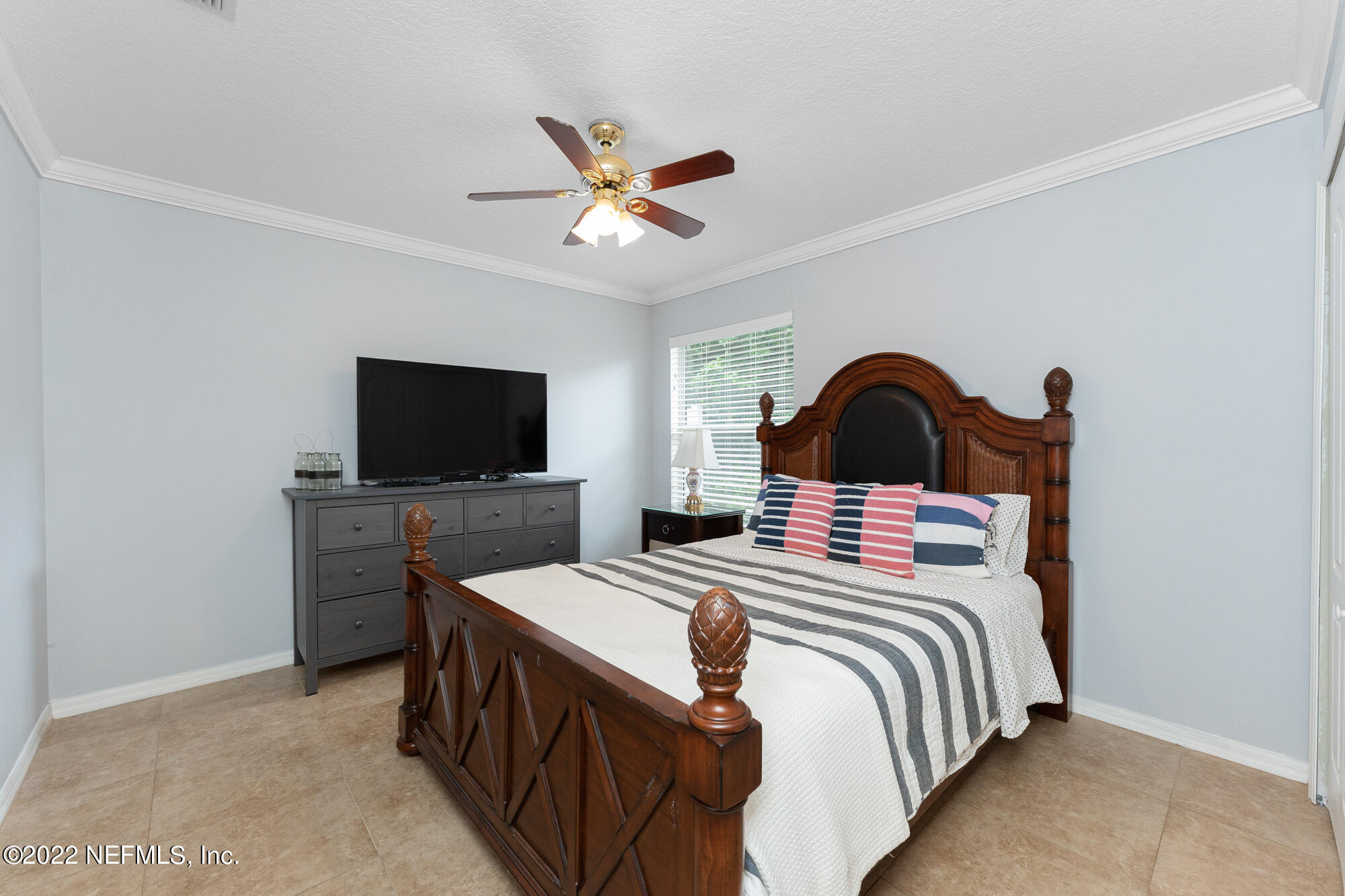 8713 Reedy Branch Drive Jacksonville, FL 32256 - Photo 26 of 38 a bedroom with a bed and a flat screen tv