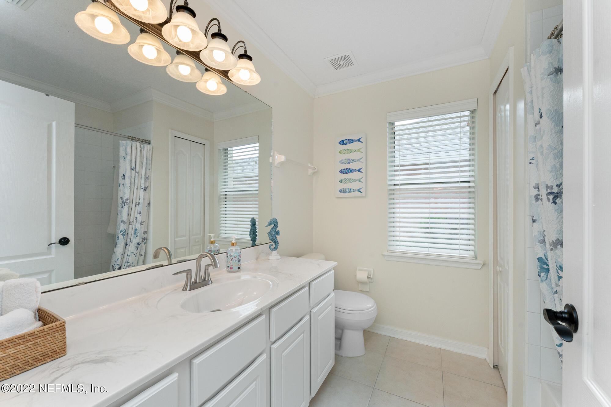 8713 Reedy Branch Drive Jacksonville, FL 32256 - Photo 27 of 38 a bathroom with a double vanity sink and a mirror