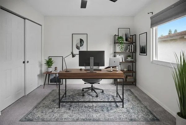an empty room with a window and a fan