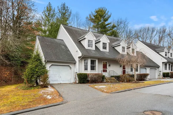 a front view of a house with a yard garage and outdoor seating