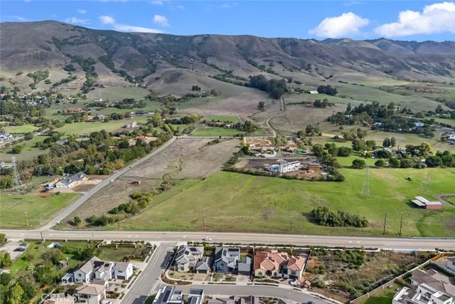a view of a lush green hillside and a mountain