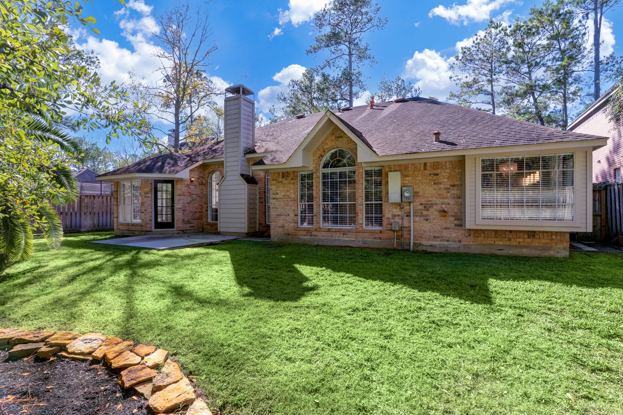 138 Summer Storm Place Spring, TX 77381 - Photo 19 of 20 Rear exterior view highlighting the home’s expansive windows and generous backyard setting.