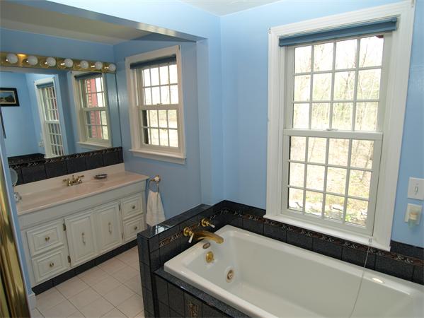 69 Teele Road Bolton, MA 01740 - Photo 11 of 17 a bathroom with a tub sink and mirror