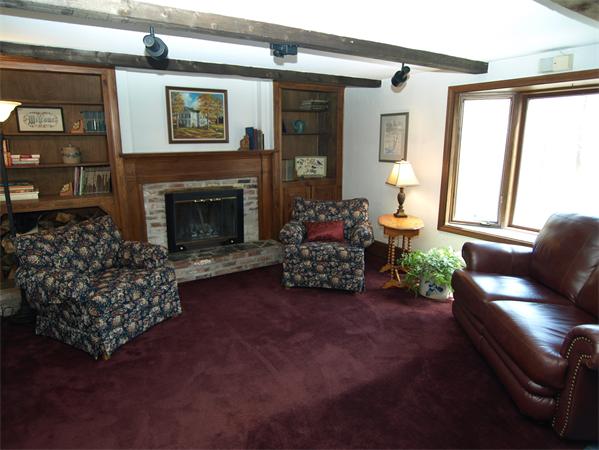 69 Teele Road Bolton, MA 01740 - Photo 8 of 17 a living room with furniture and a fireplace