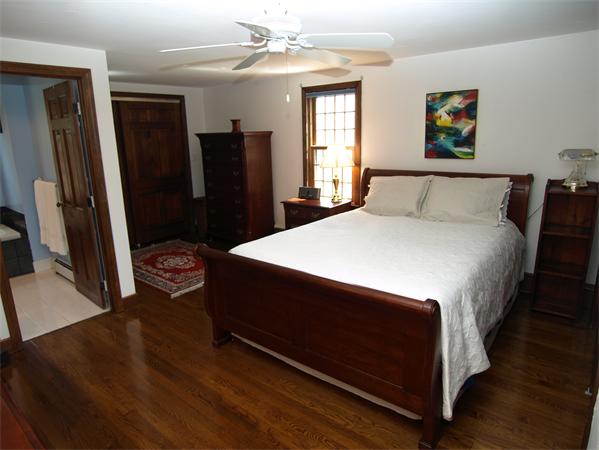 69 Teele Road Bolton, MA 01740 - Photo 10 of 17 a bed sitting in a bedroom next to a window