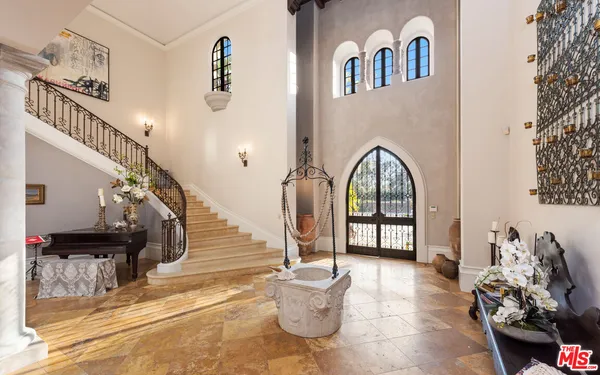 a living room with furniture a fireplace and a chandelier