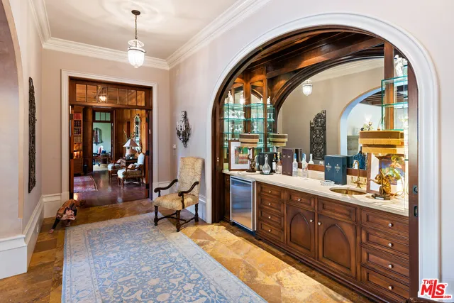 a living room with furniture a chandelier and a fireplace