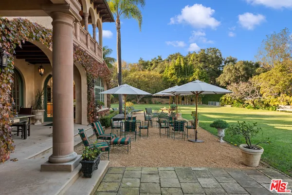 a view of a house with a yard and sitting area