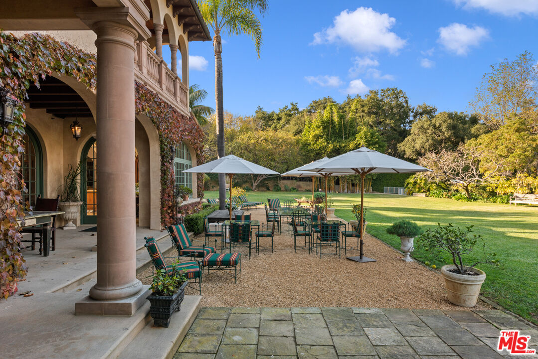 2733 Sycamore Canyon Road Montecito, CA 93108 - Photo 9 of 30 a view of a patio with a table and chairs under an umbrella