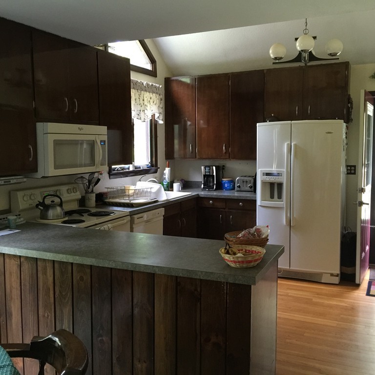 45 Gregory Road Princeton, MA 01541 - Photo 12 of 30 a kitchen with sink a refrigerator and chairs