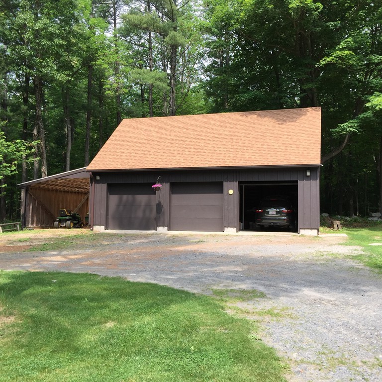 45 Gregory Road Princeton, MA 01541 - Photo 4 of 30 a front view of a house with a yard and garage