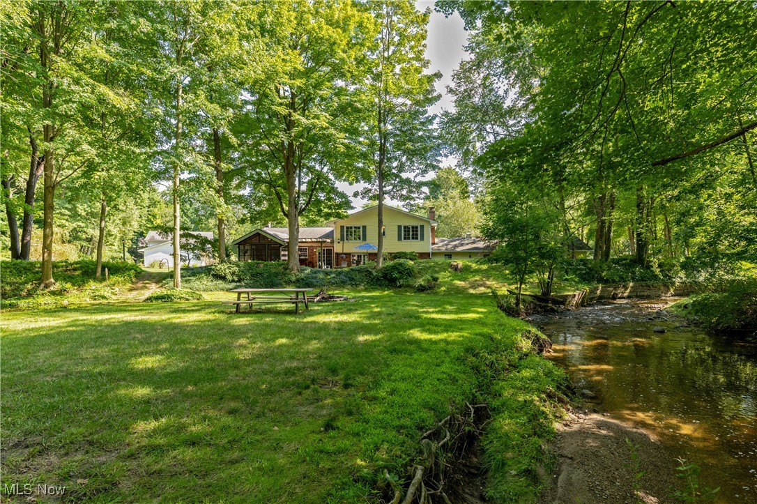 8062 Chagrin Road Chagrin Falls, OH 44023 - Photo 46 of 50 Your view from the back reveals a breathtaking, park-like setting—complete with a private picnic area, cozy campfire, and your own gently flowing, meandering stream. It’s the perfect place to pitch a tent and spend a magical night beneath the stars.