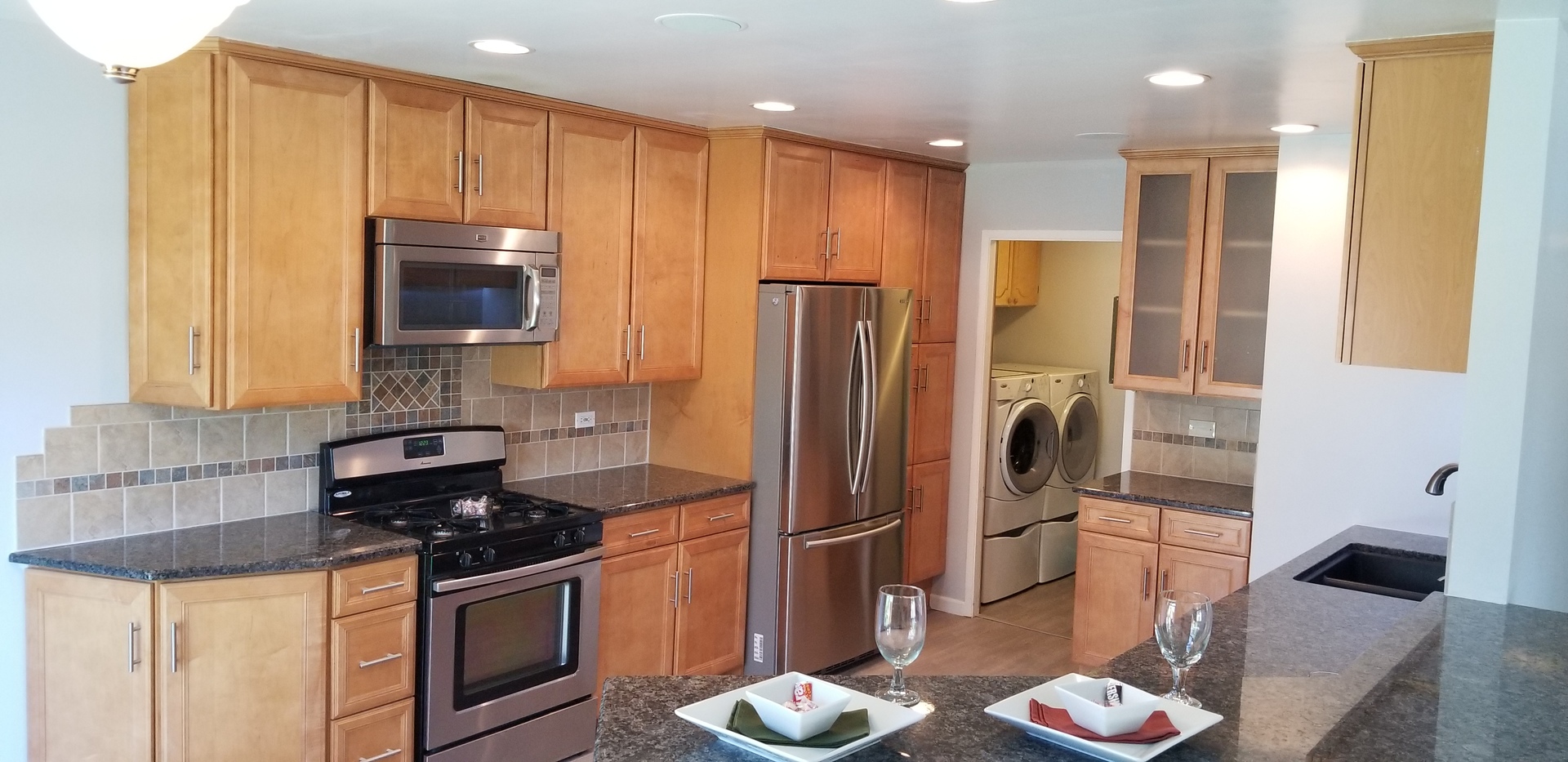 4484 Brookhaven Road Gurnee, IL 60031 - Photo 4 of 13 a kitchen with stainless steel appliances granite countertop a refrigerator a stove and a sink with wooden floor