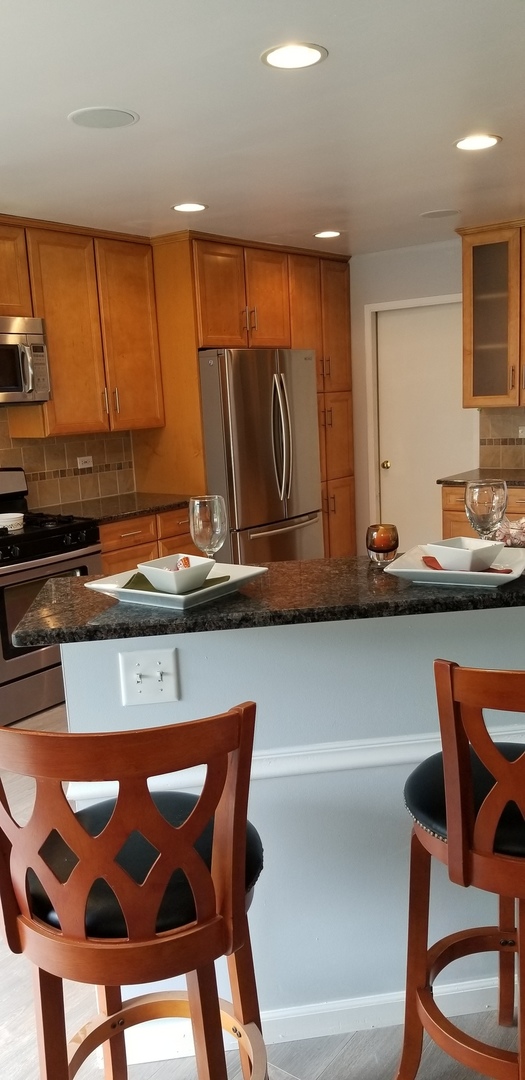 4484 Brookhaven Road Gurnee, IL 60031 - Photo 6 of 13 a kitchen with a sink a table and chairs in it