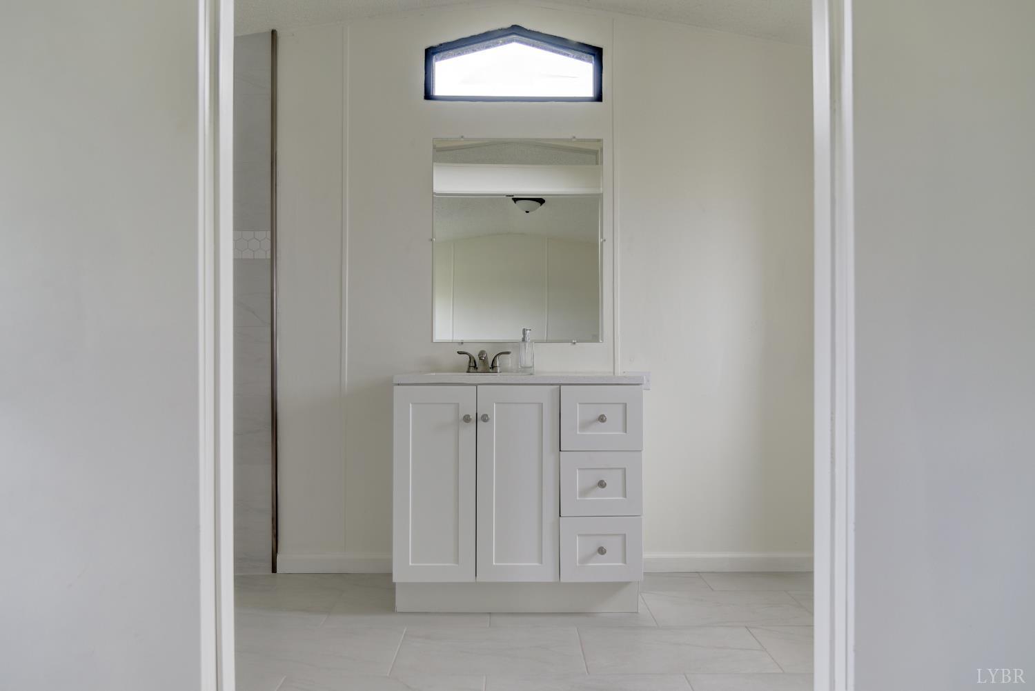 195 Dews Road Hurt, VA 24563 - Photo 14 of 37 a bathroom with a sink and a mirror