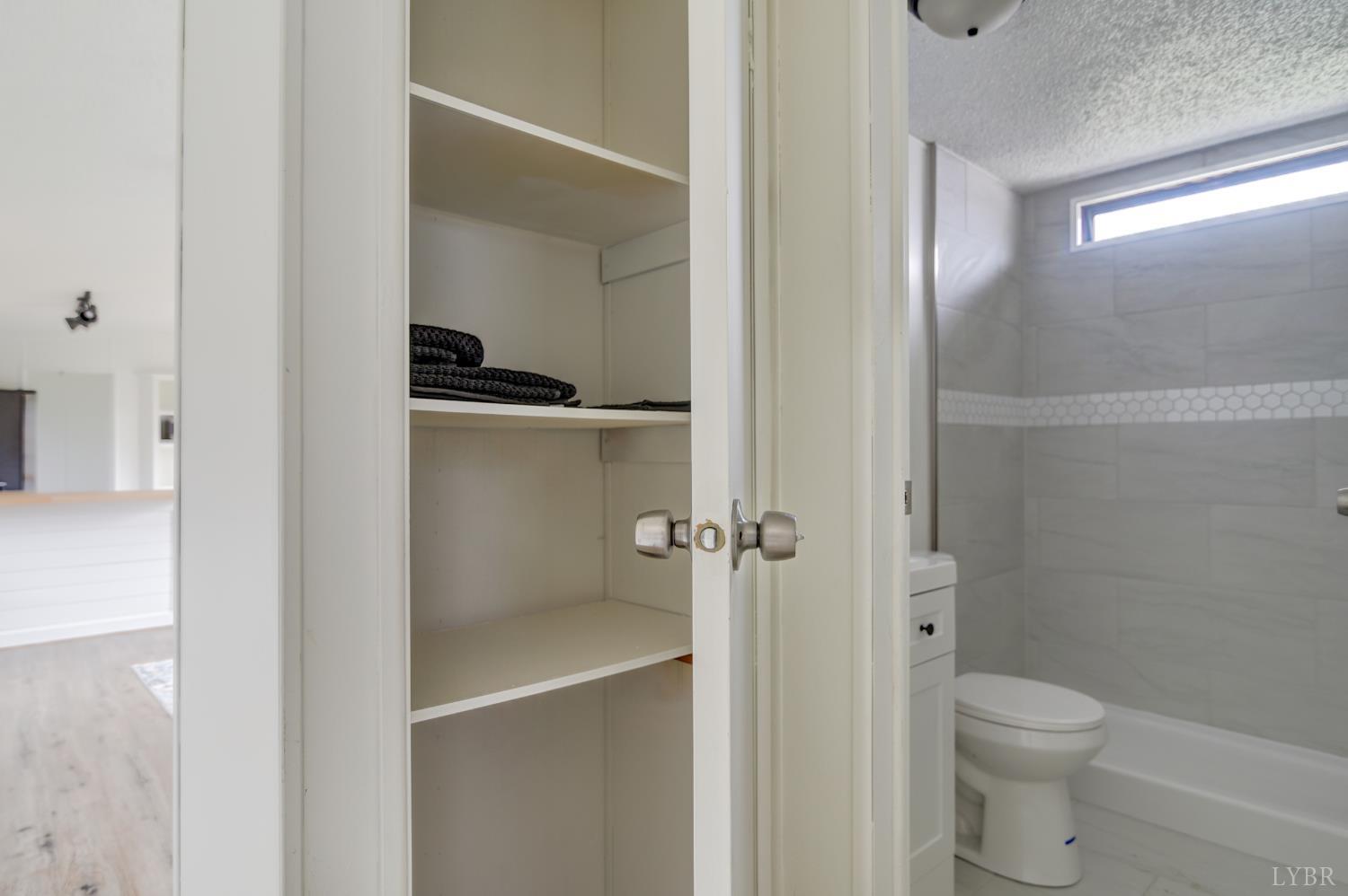 195 Dews Road Hurt, VA 24563 - Photo 19 of 37 a bathroom with a granite countertop toilet a sink and shower