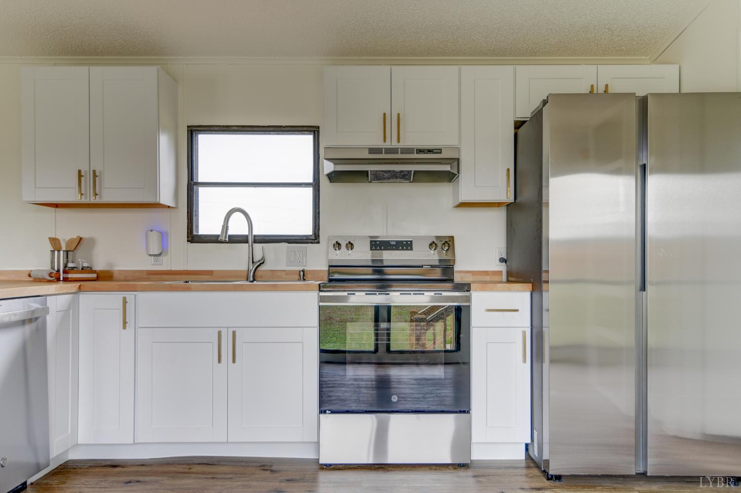 195 Dews Road Hurt, VA 24563 - Photo 5 of 37 a kitchen with a sink and a refrigerator