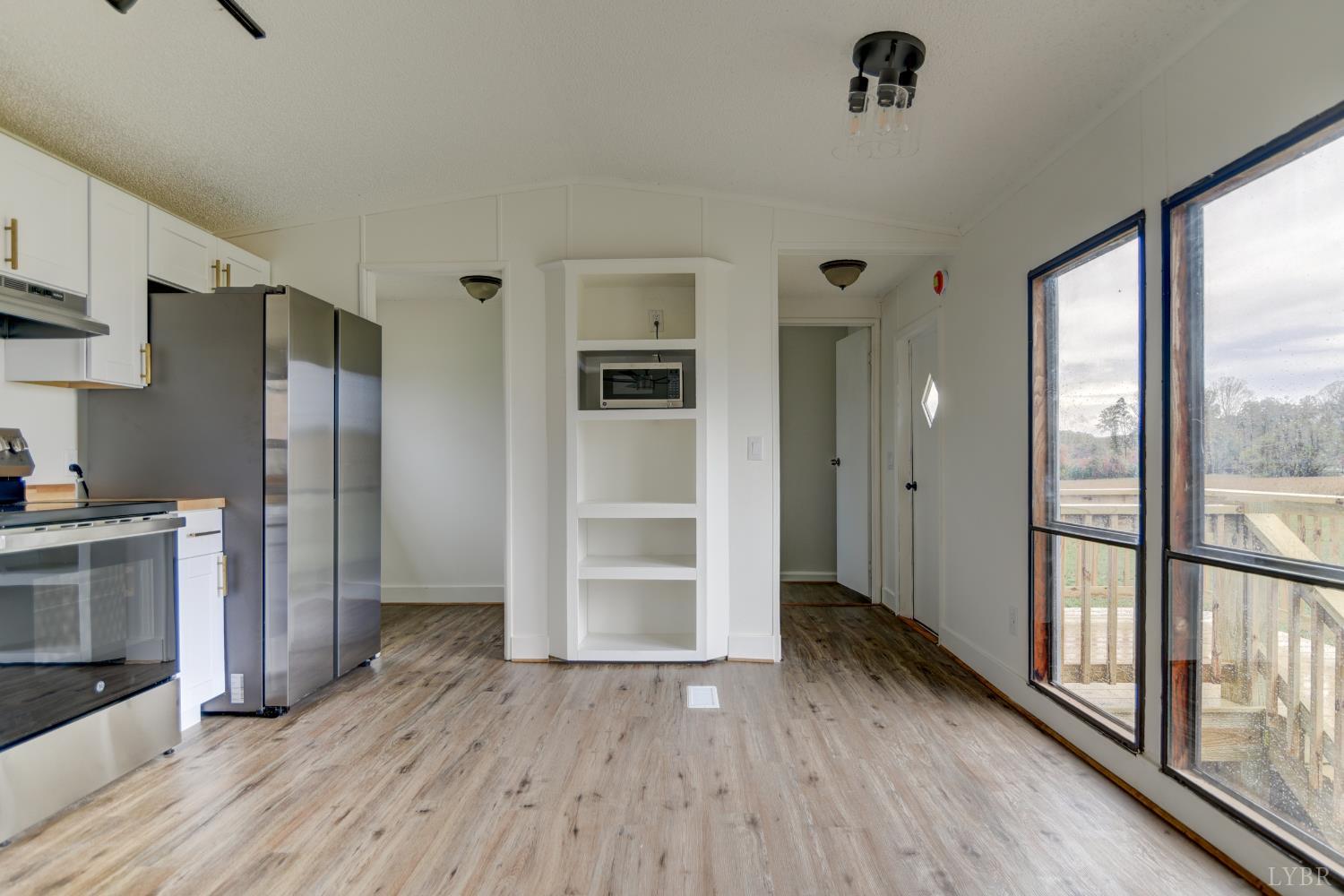 195 Dews Road Hurt, VA 24563 - Photo 9 of 37 a view of a kitchen with wooden floor and a refrigerator