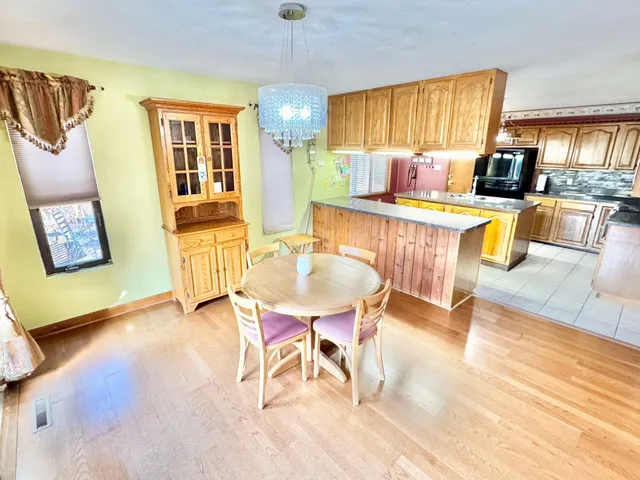 a view of a chairs and table on the wooden floor