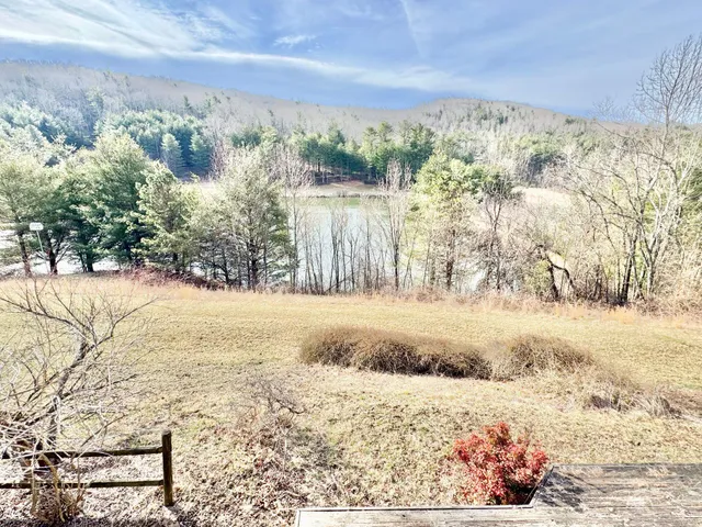 an empty room with wooden floor and door