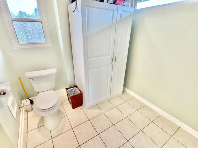a view of a dry yard with wooden fence
