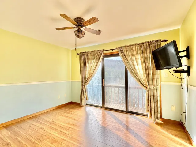 an aerial view of residential houses with outdoor space and lake view