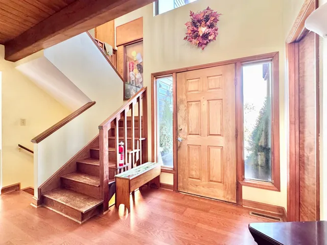 a living room with fireplace furniture and a wooden floor