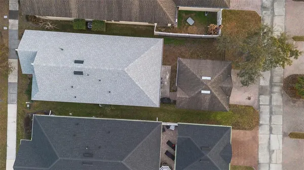 an aerial view of a house with a yard