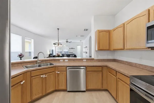 a kitchen with a sink stove and cabinets