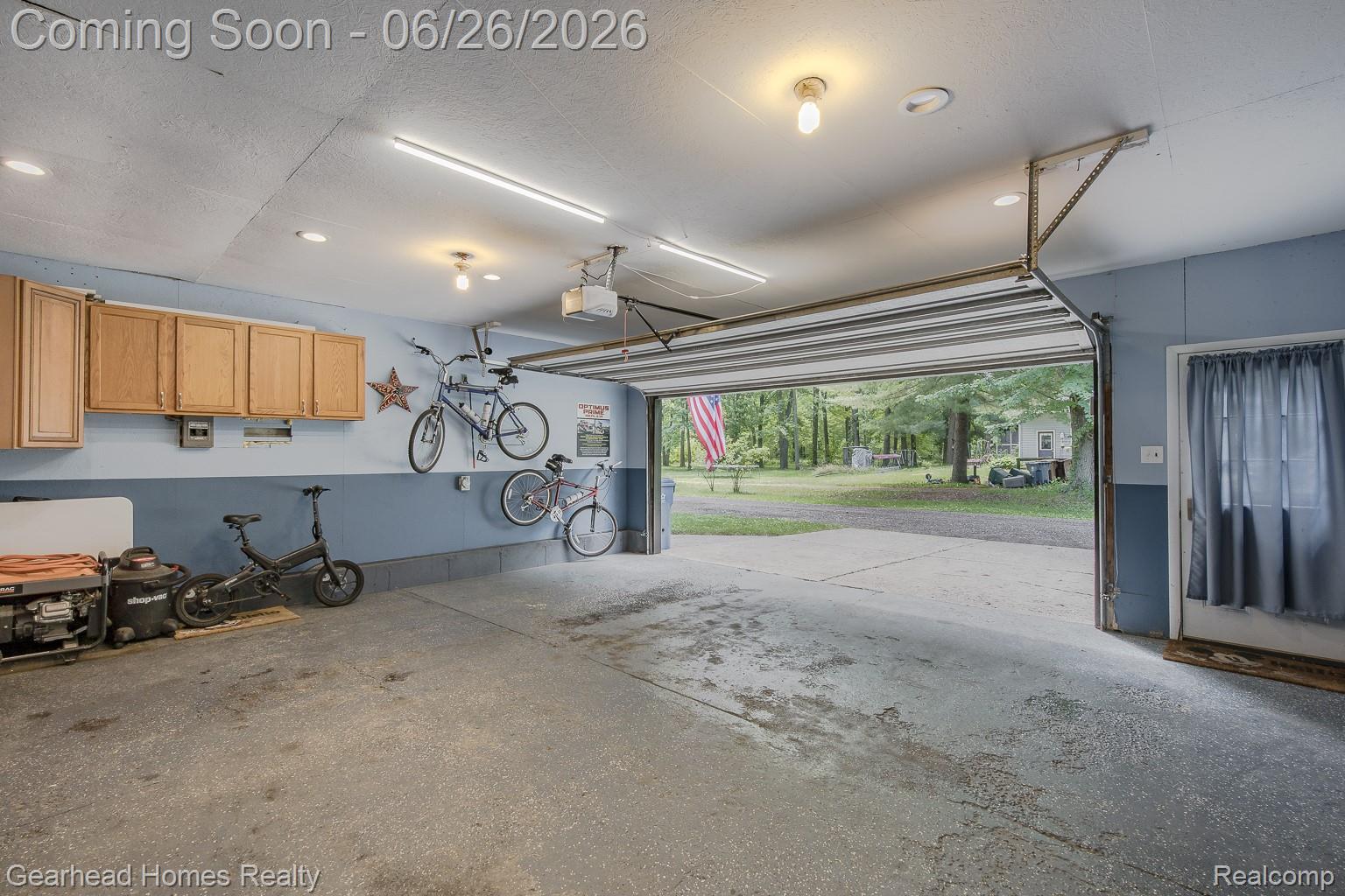 12364 Morrish Road Clio, MI 48420 - Photo 52 of 81 Spacious garage featuring a durable concrete floor, overhead storage cabinetry, and ample wall space