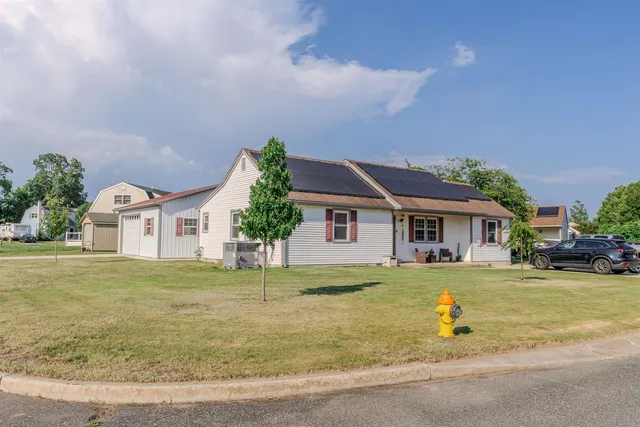 a front view of a house with a garden and plants