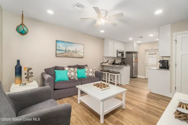a living room with furniture and kitchen view