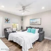 a bedroom with a bed and a chandelier